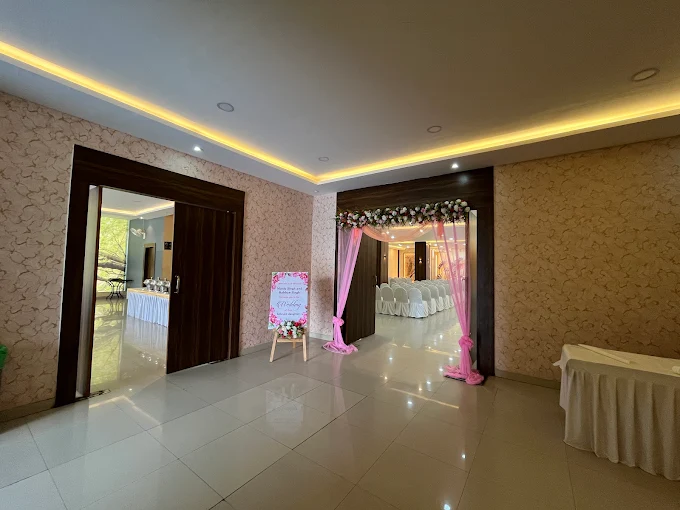 Lobby with pink drape entrance and welcome board